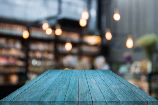 Blue table top wood with coffee shop blurred background with bokeh