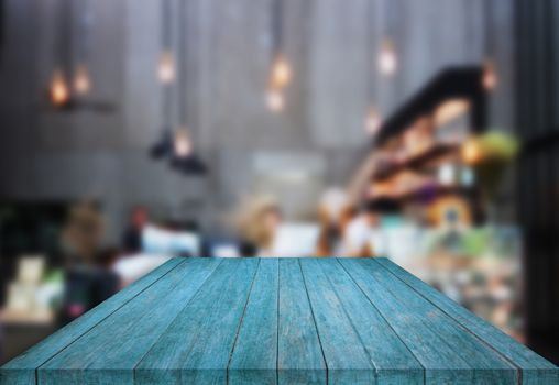 Blue table top wooden with blurred background in coffee shop, stock photo