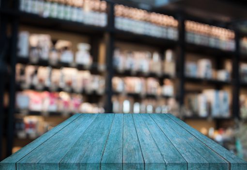 Blue tabletop wooden with blurred cafe background. product display template