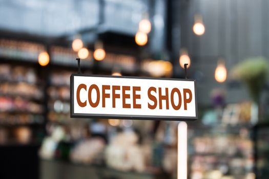 Coffee shop signboard with coffee shop blurred background with bokeh