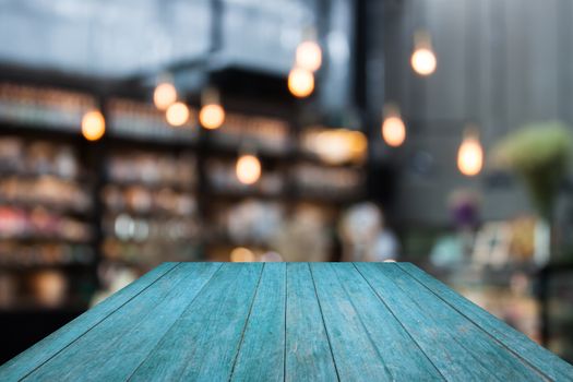 Perspective blue wooden on coffee shop blurred background with bokeh, stock photo