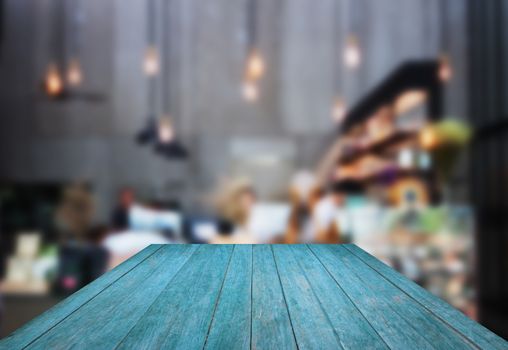 Perspective blue wooden with blurred background in coffee shop, stock photo