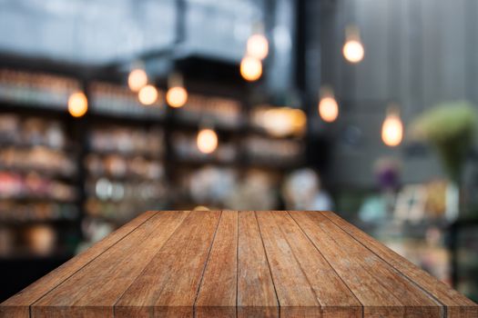 Table top wood with coffee shop blurred background with bokeh