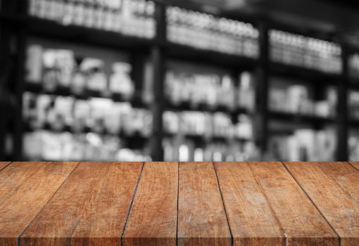 Wooden tabletop with black and white cafe blurred background, stock photo