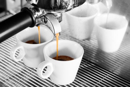 Prepares espresso in coffee shop with black and white background, stock photo