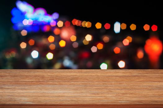 Wooden tabletop with abstract blurred lights, stock photo