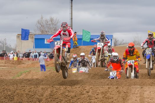 Volgograd, Russia - April 19, 2015: Motorcycle racer after the start of driving on the road by a large group, at the stage of the Open Championship Motorcycle Cross Country Cup Volgograd Region Governor
