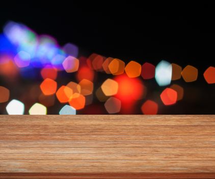 Wooden tabletop with abstract night lights, stock photo