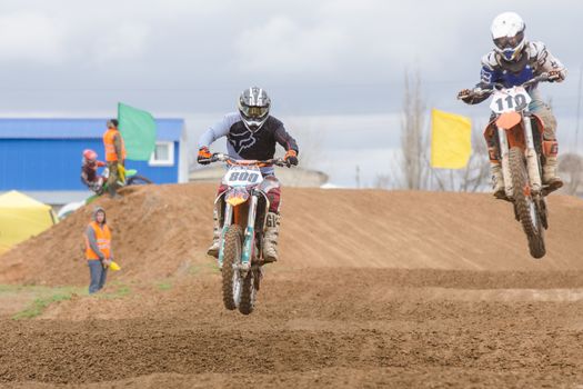 Volgograd, Russia - April 19, 2015: Two riders on the track, at the stage of the Open Championship Motorcycle Cross Country Cup Volgograd Region Governor