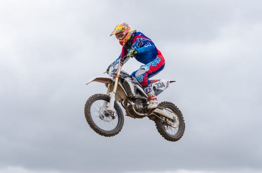 Volgograd, Russia - April 19, 2015: Motorcycle racer flying jumping on the trampoline, on the stage of the open championship motorcycling Cup cross-country Volgograd Region Governor