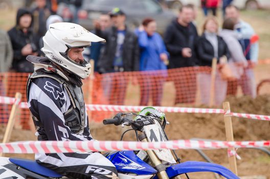 Volgograd, Russia - April 19, 2015: Motorcycle racer smiles before the start of the competition, at the stage of the Open Championship Motorcycle Cross Country Cup Volgograd Region Governor