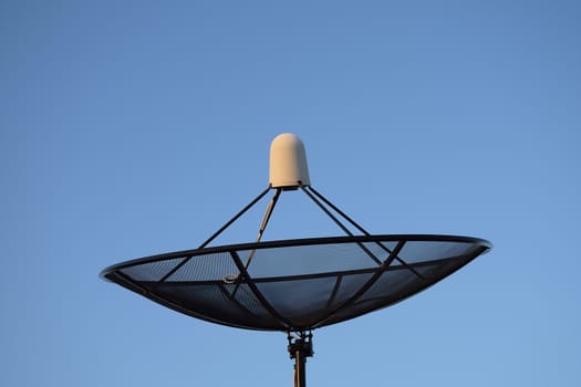 Satellite dish on clear sky background.