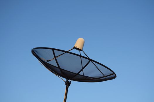 Satellite dish on clear sky background.