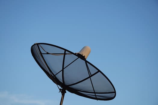 Satellite dish on clear sky background.
