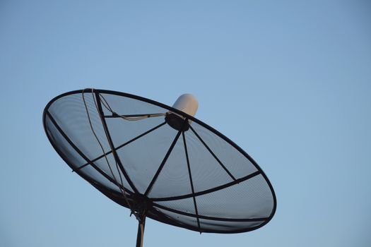 Satellite dish on clear sky background.