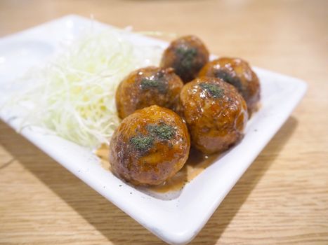 Japanese food Tako Yaki on white plate.