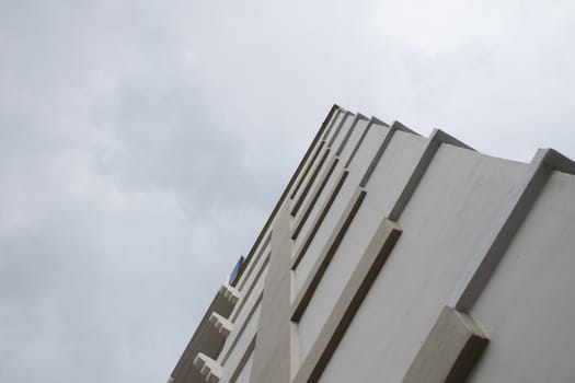 Look up at apartment housing in Thailand. Step of building.