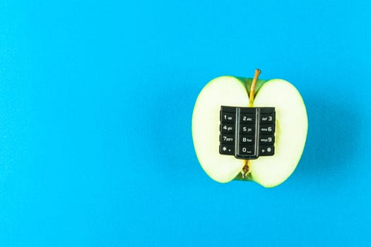 Apple with alphanumeric keyboard on blue background