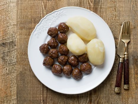 close up of rustic swedish meatball and potato