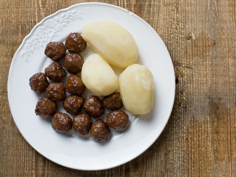 close up of rustic swedish meatball and potato