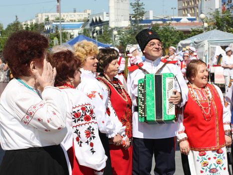 Tyumen, Russia - May 26 2012. Festival of national cultures Friendship Bridge. Peoples in Kazakh national dress ready for a concert. In the backyard are the presentation of the national dishes, show rituals are examples of arts and crafts, conduct master classes of traditional national crafts and trades and local cuisine.