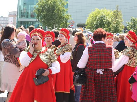 Tyumen, Russia - May 26 2012. Festival of national cultures Friendship Bridge. Peoples in Kazakh national dress ready for a concert. In the backyard are the presentation of the national dishes, show rituals are examples of arts and crafts, conduct master classes of traditional national crafts and trades and local cuisine.