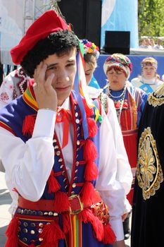 Tyumen, Russia - May 26 2012. Festival of national cultures Friendship Bridge. Peoples in Kazakh national dress ready for a concert. In the backyard are the presentation of the national dishes, show rituals are examples of arts and crafts, conduct master classes of traditional national crafts and trades and local cuisine.