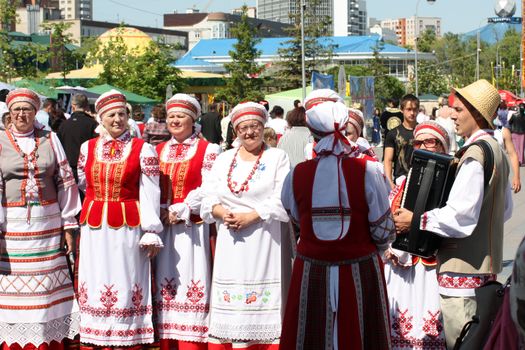 Tyumen, Russia - May 26 2012. Festival of national cultures Friendship Bridge. Peoples in Kazakh national dress ready for a concert. In the backyard are the presentation of the national dishes, show rituals are examples of arts and crafts, conduct master classes of traditional national crafts and trades and local cuisine.