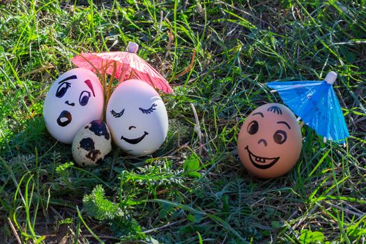 Funny eggs imitating white parents with versicolored baby and coloured male friend