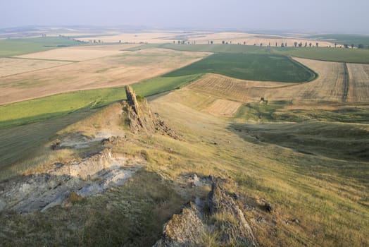 Beautiful rocks on the hill and golden fields, natural geological reservation - The Rock with human shape - from Serbesti, Romania