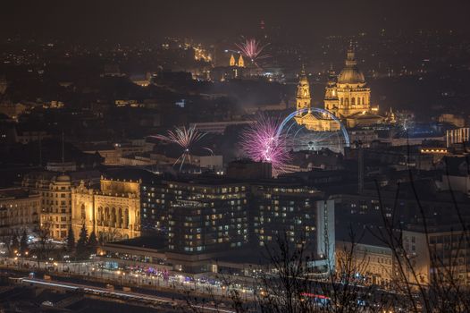 New Year Celebration. Fireworks over Budapest, Hungary. St. Stephen's Basilica and Sziget Eye.