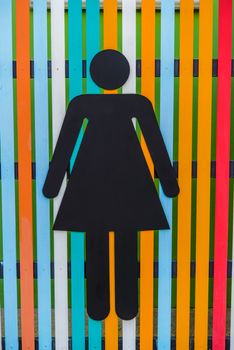 Women toilet signs on wooden plate colorful.