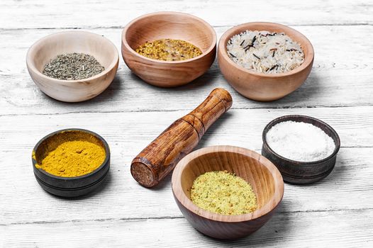 Spices and seasoning to the dishes in wooden bowls