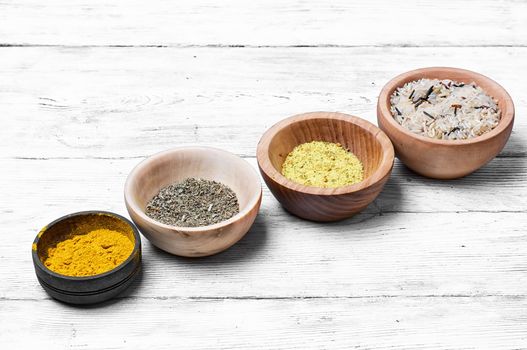 Spices and seasoning to the dishes in wooden bowls