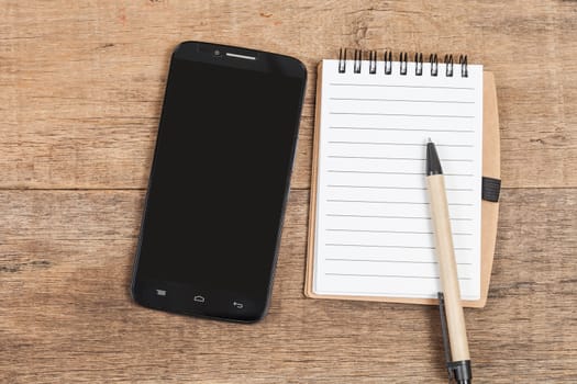 Note book  and smart phone on wood table