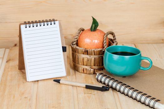note book  and pen on wood table