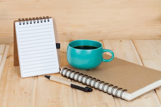 note book  and pen on wood table