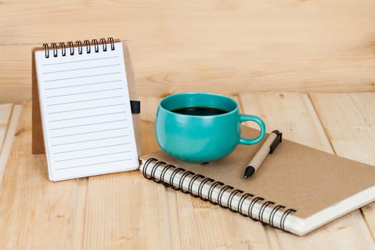 note book  and pen on wood table