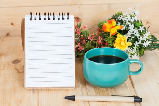 note book  and pen on wood table