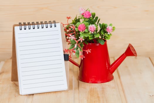 note book  and vase on wood table