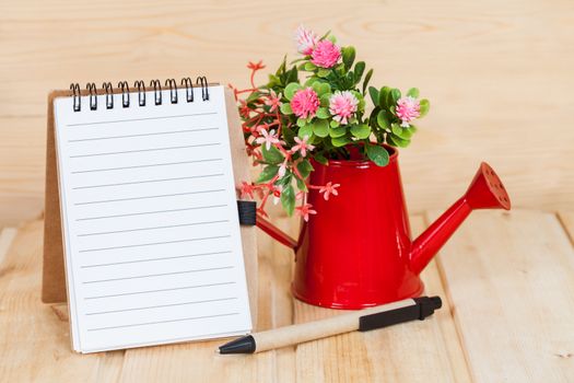 note book  and vase on wood table
