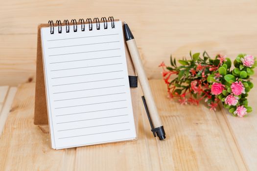 note book  and pen on wood table