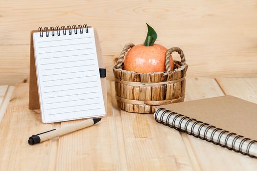 note book  and pen on wood table