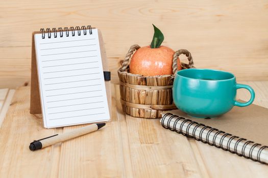 note book  and pen on wood table