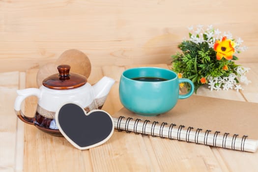 cup of coffee and book on  wood table