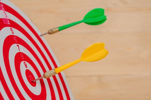 Dart arrow hitting in bullseye on dartboard