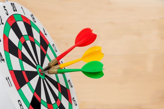 Dart arrow hitting in bullseye on dartboard