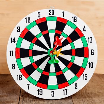 Dart arrow hitting in bullseye on dartboard