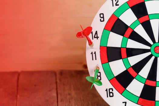 Dart arrow hitting in bullseye on dartboard
