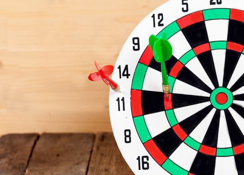 Dart arrow hitting in bullseye on dartboard